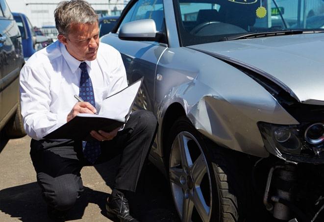 man signing paperwork for auto insurance